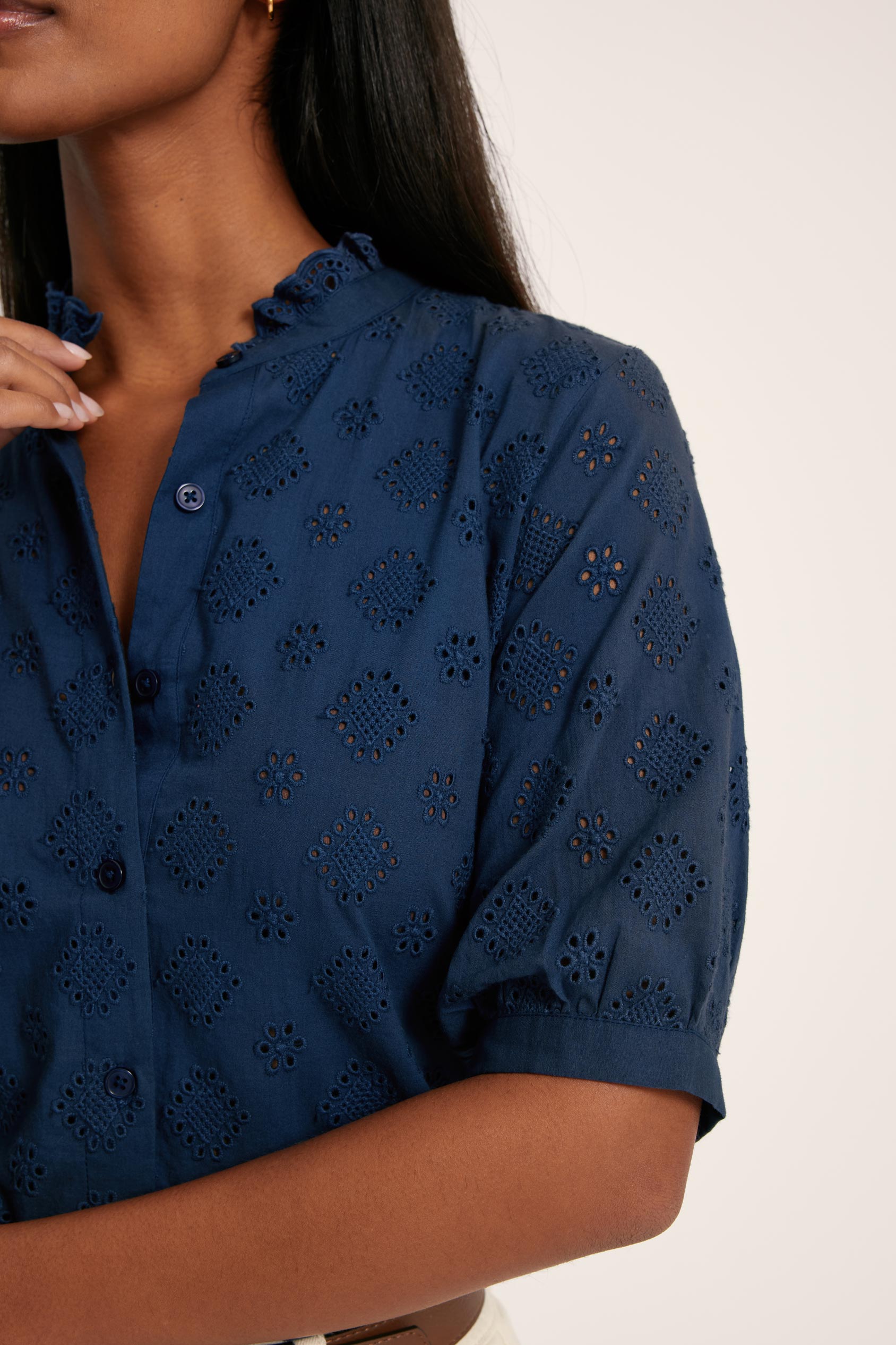 Navy blue patterned shirt worn by a person on a white background