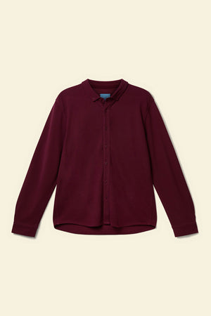 Maroon shirt on a beige background