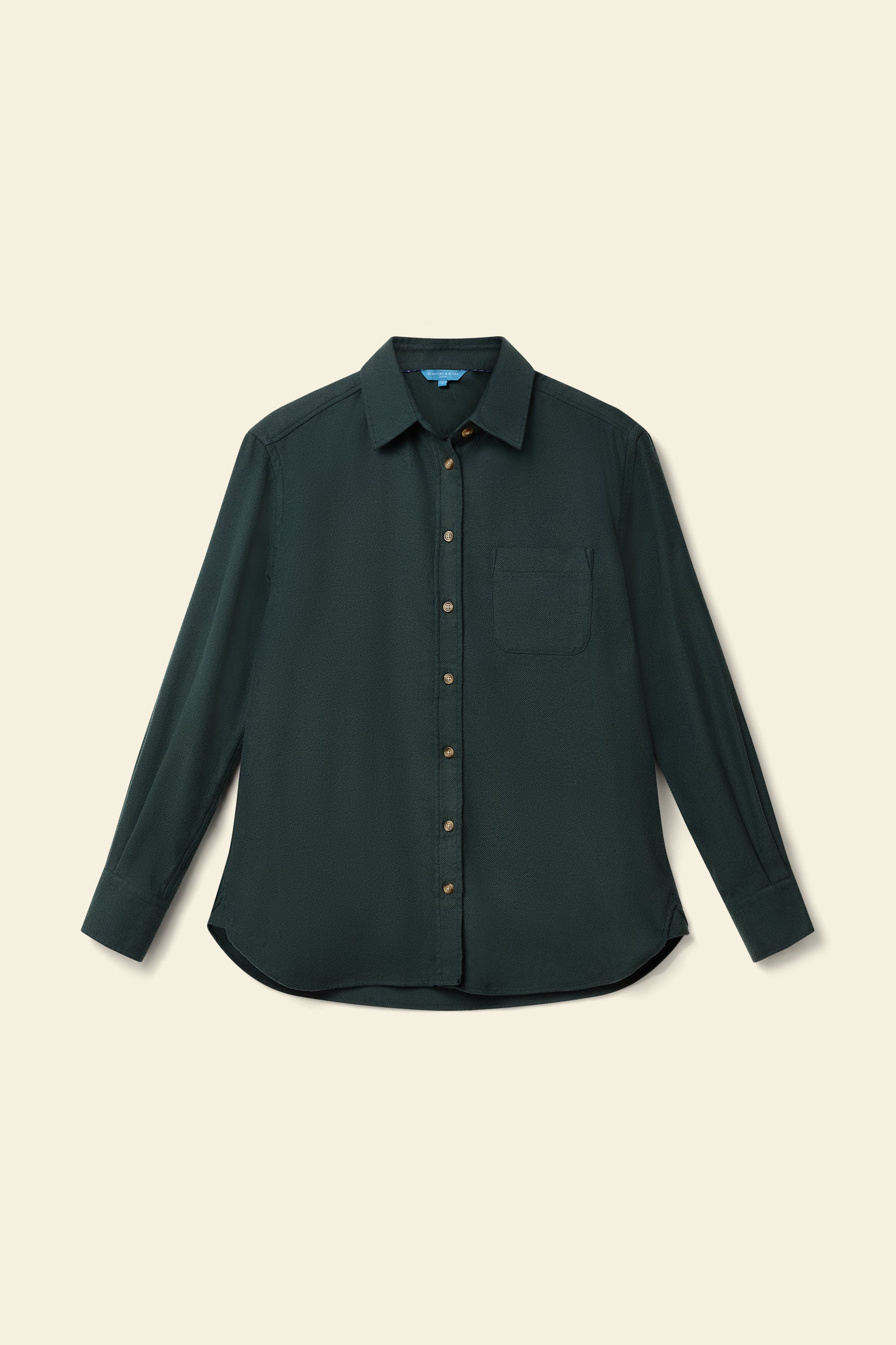 Dark green button-up shirt on a beige background