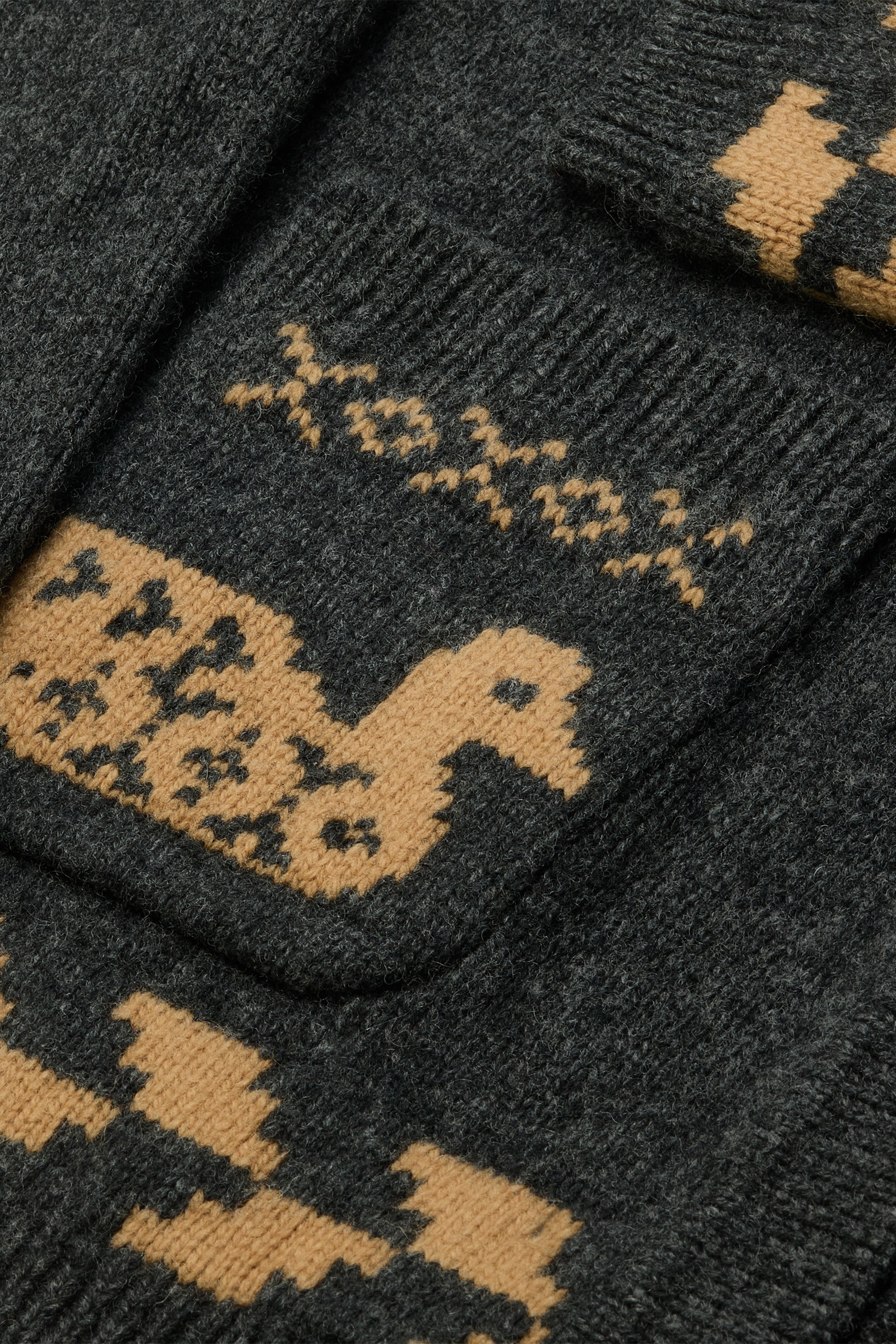 Dark gray socks with yellow pattern and 'XOXO' text on a matching background