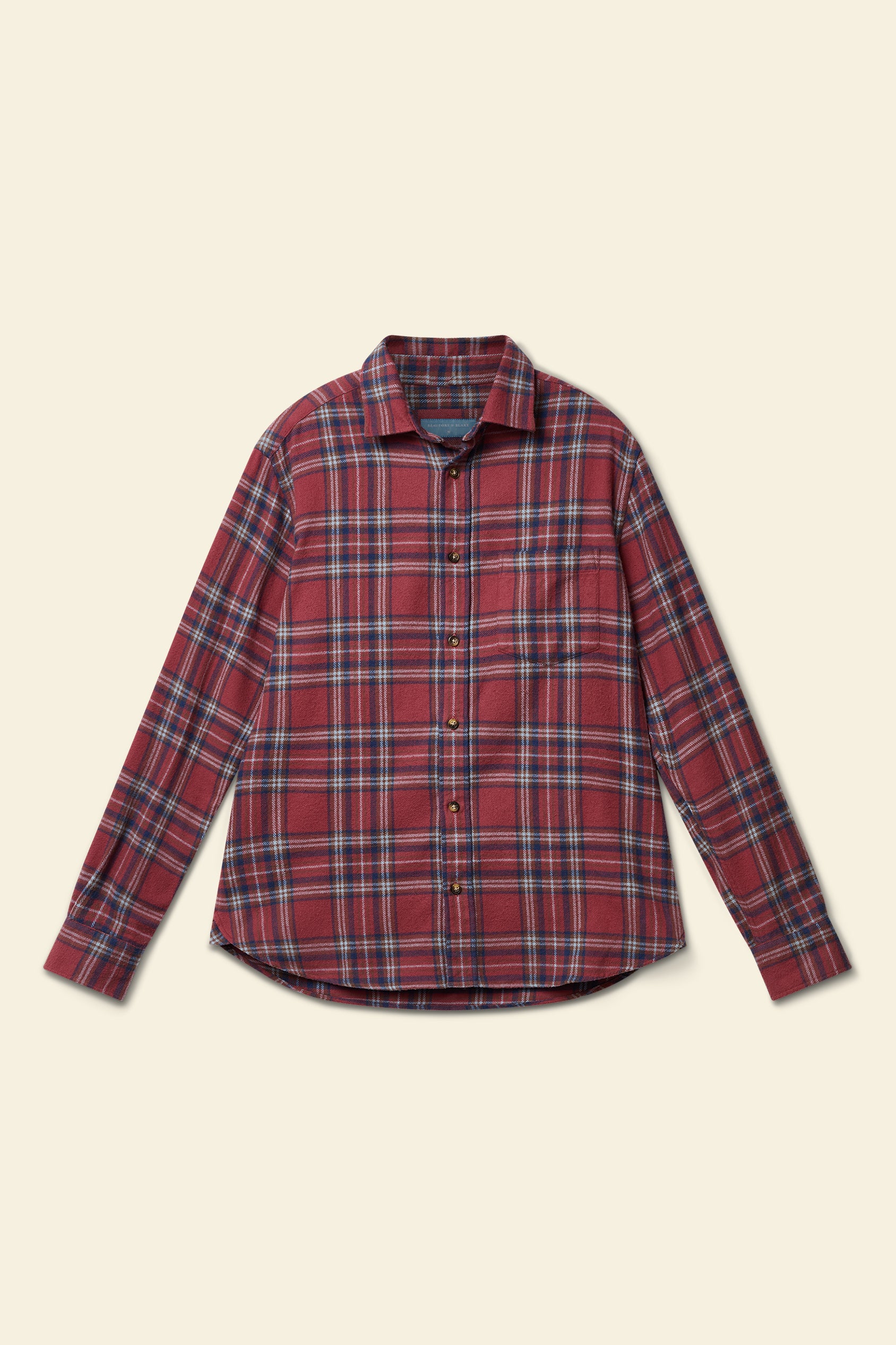 Red and blue plaid shirt on a beige background