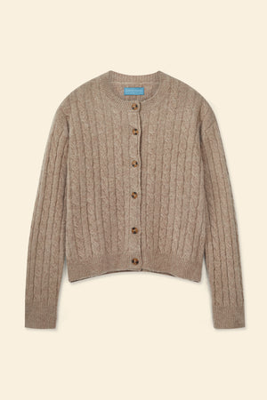 Brown cable knit cardigan on a beige background