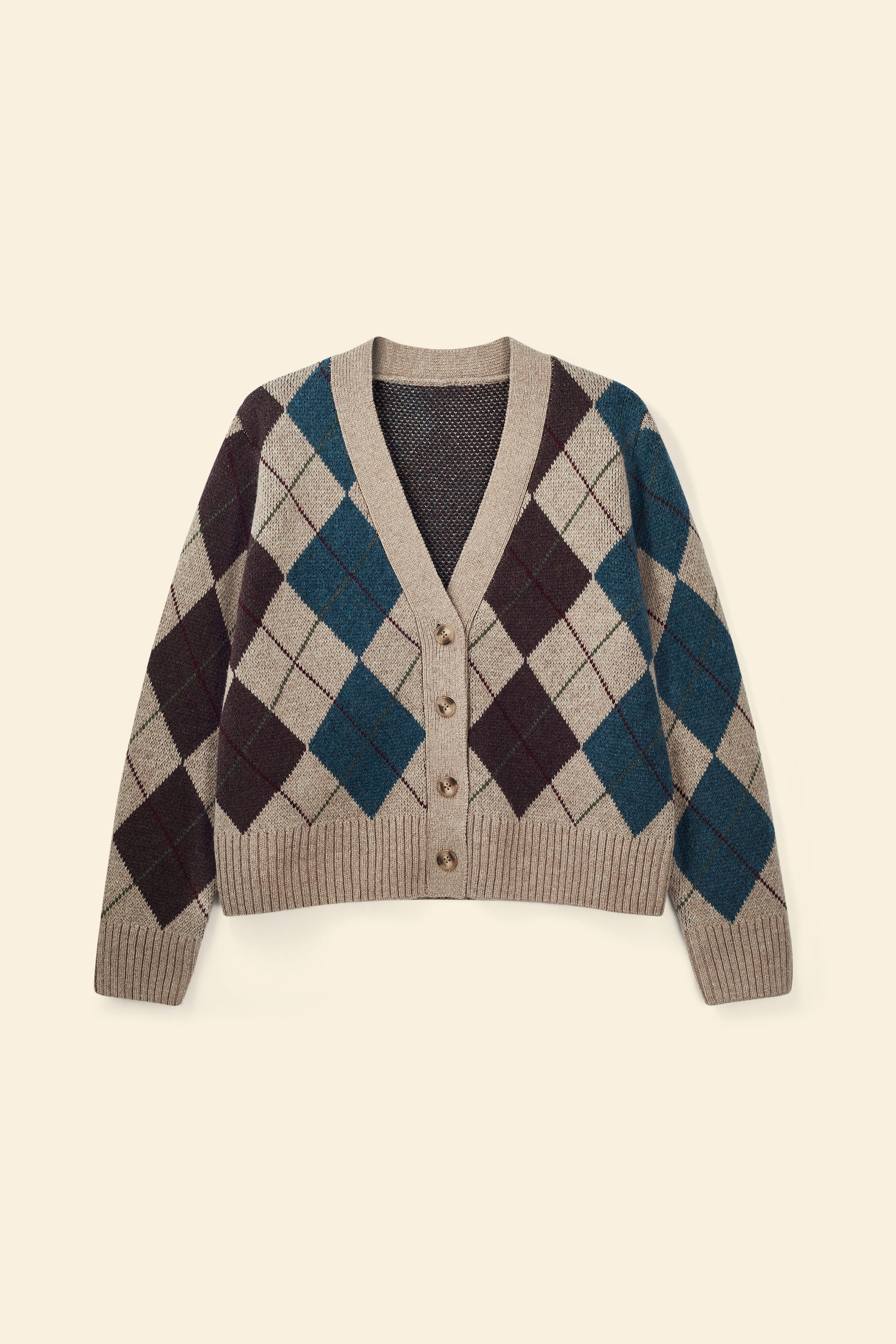 Argyle patterned cardigan on a beige background