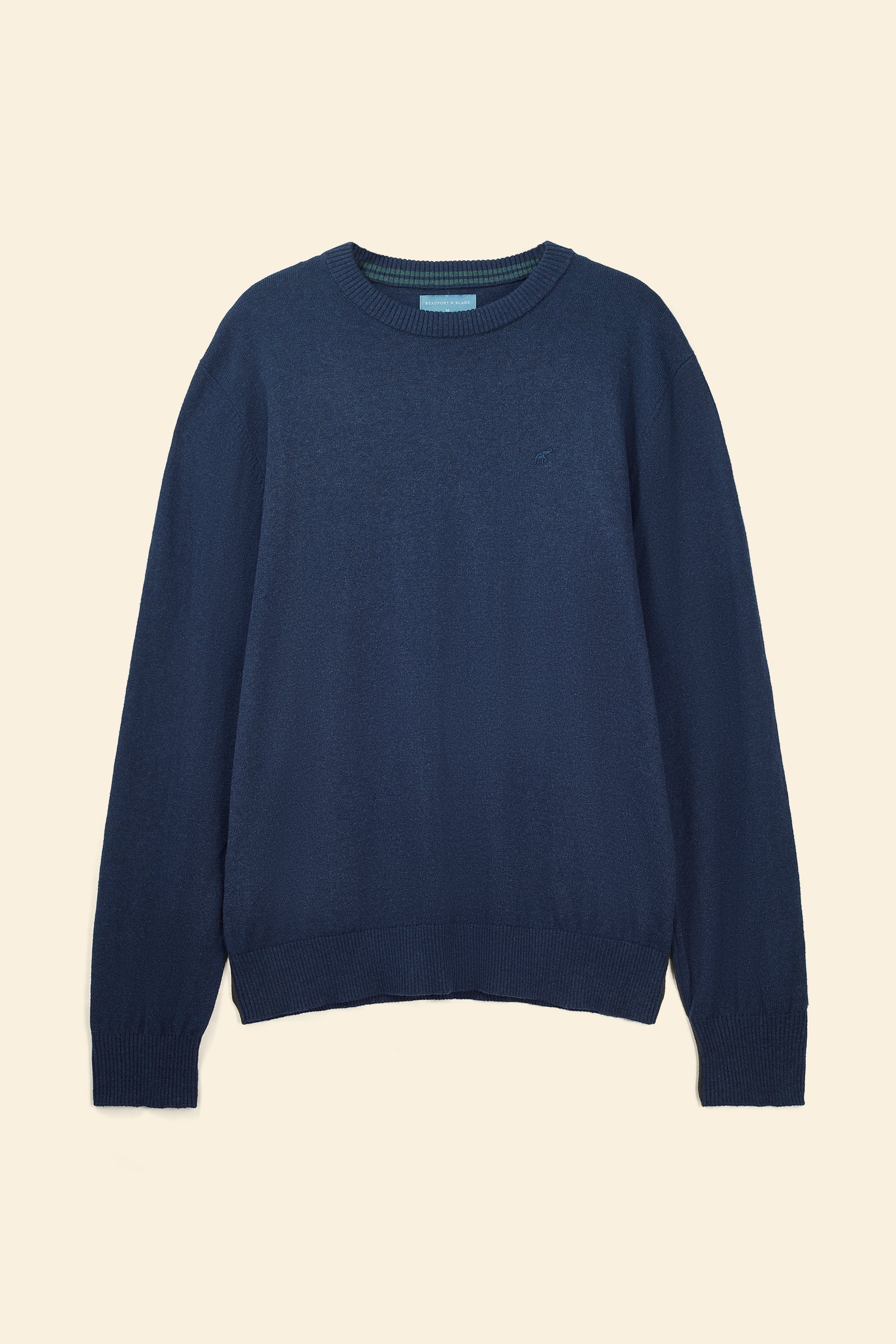 Navy blue sweater on a beige background