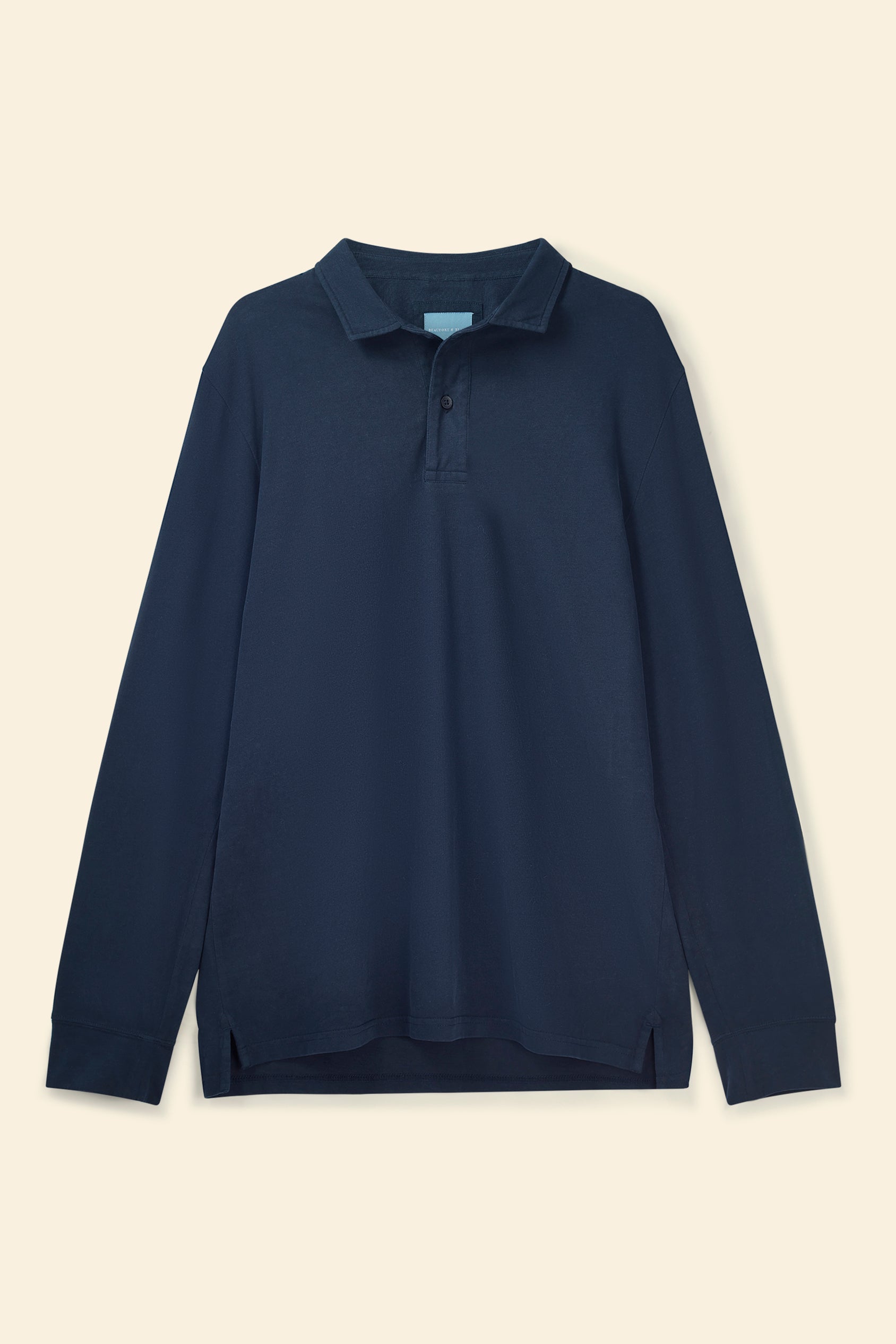 Navy long-sleeve polo shirt on a beige background