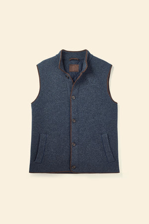 Blue vest with buttons on a beige background