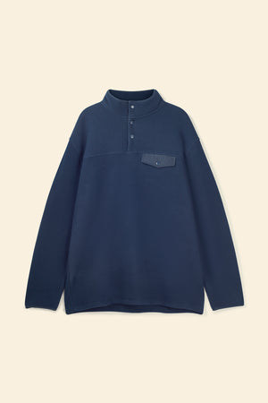 Navy blue pullover with a pocket on a beige background