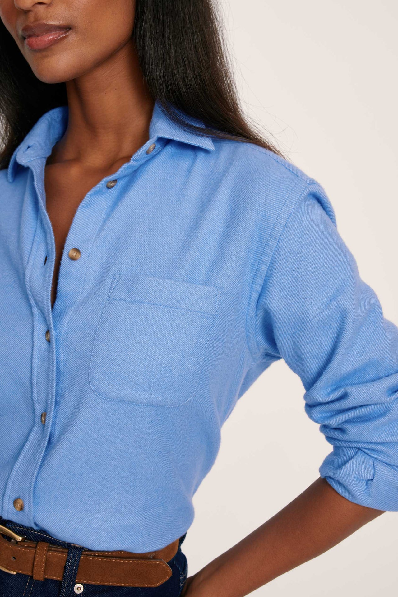 Woman wearing a blue shirt with a blurred background
