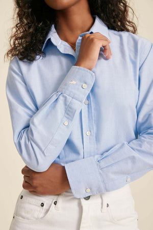 Light blue button-up shirt worn by a person with a neutral background