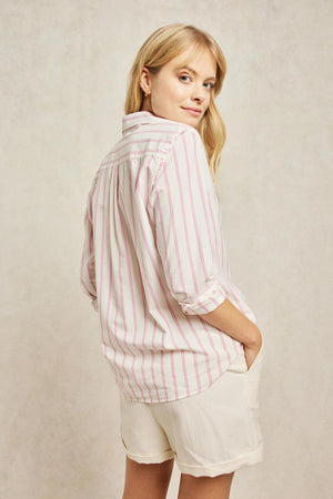 Classic collar women’s pink stripe shirt, boyfriend fit with back box pleat and curved hem. Classic collar, pastel stripes, and elephant embroidery on the cuff. Woven from soft blend of organic cotton. Casual wear. Size XS, S, M, L, XL. Made in Portugal. Machine wash.