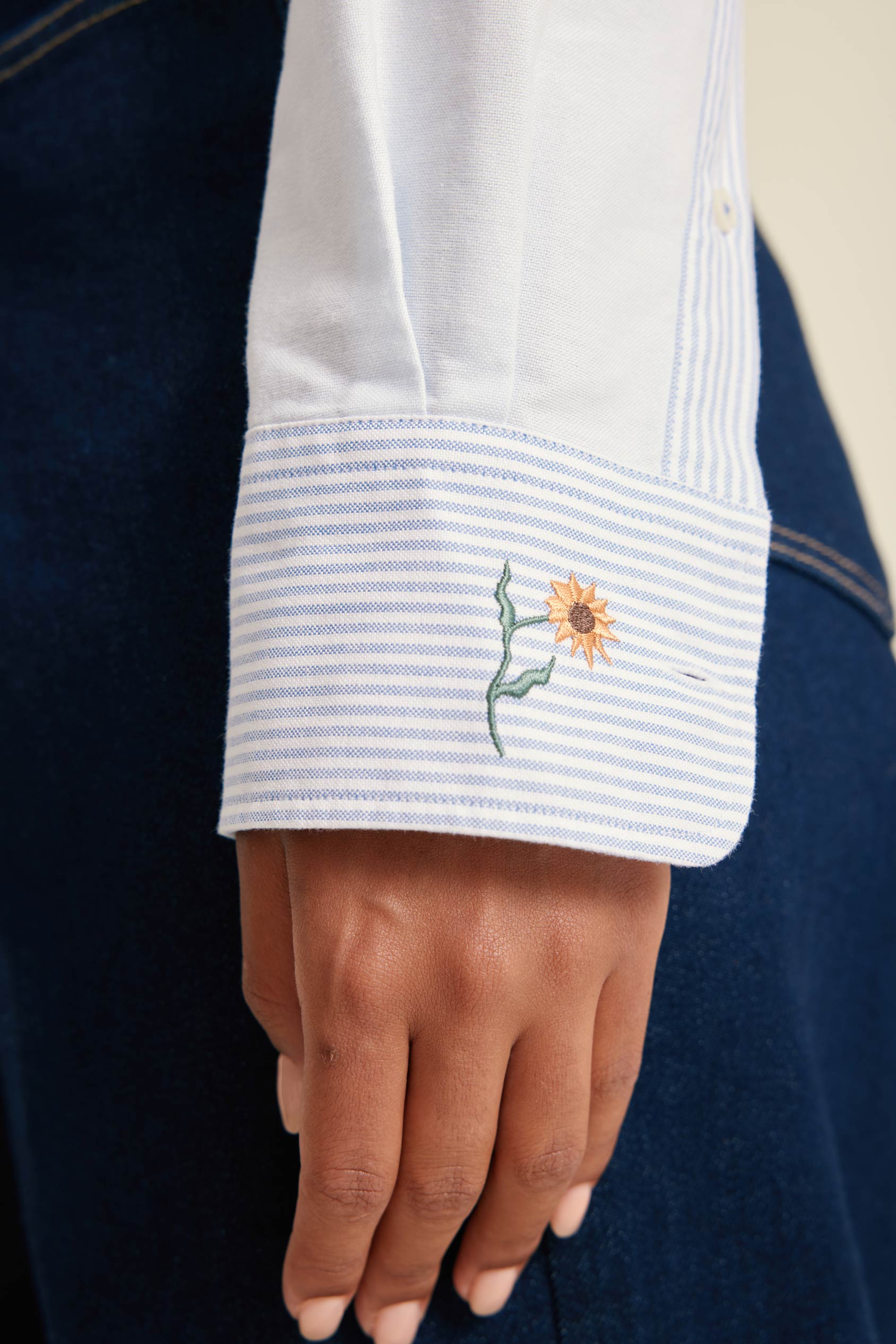 Close-up of a white shirt with a sunflower design on a blue background