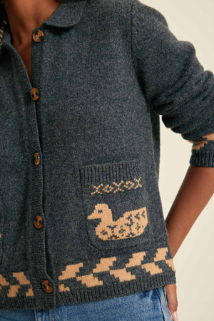 Dark blue knitted cardigan with a duck pattern on a neutral background
