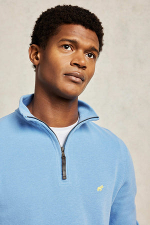 Super soft fine rib sky blue men's sweat with half zip feature. 100% Cotton. The Frampton half zip is crafted from super-soft ribbed cotton. Made in Portugal. Smart casual wear. Machine wash. Size S, M, L, XL, XXL.