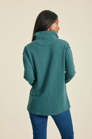 Person wearing a pine sweat on a beige background