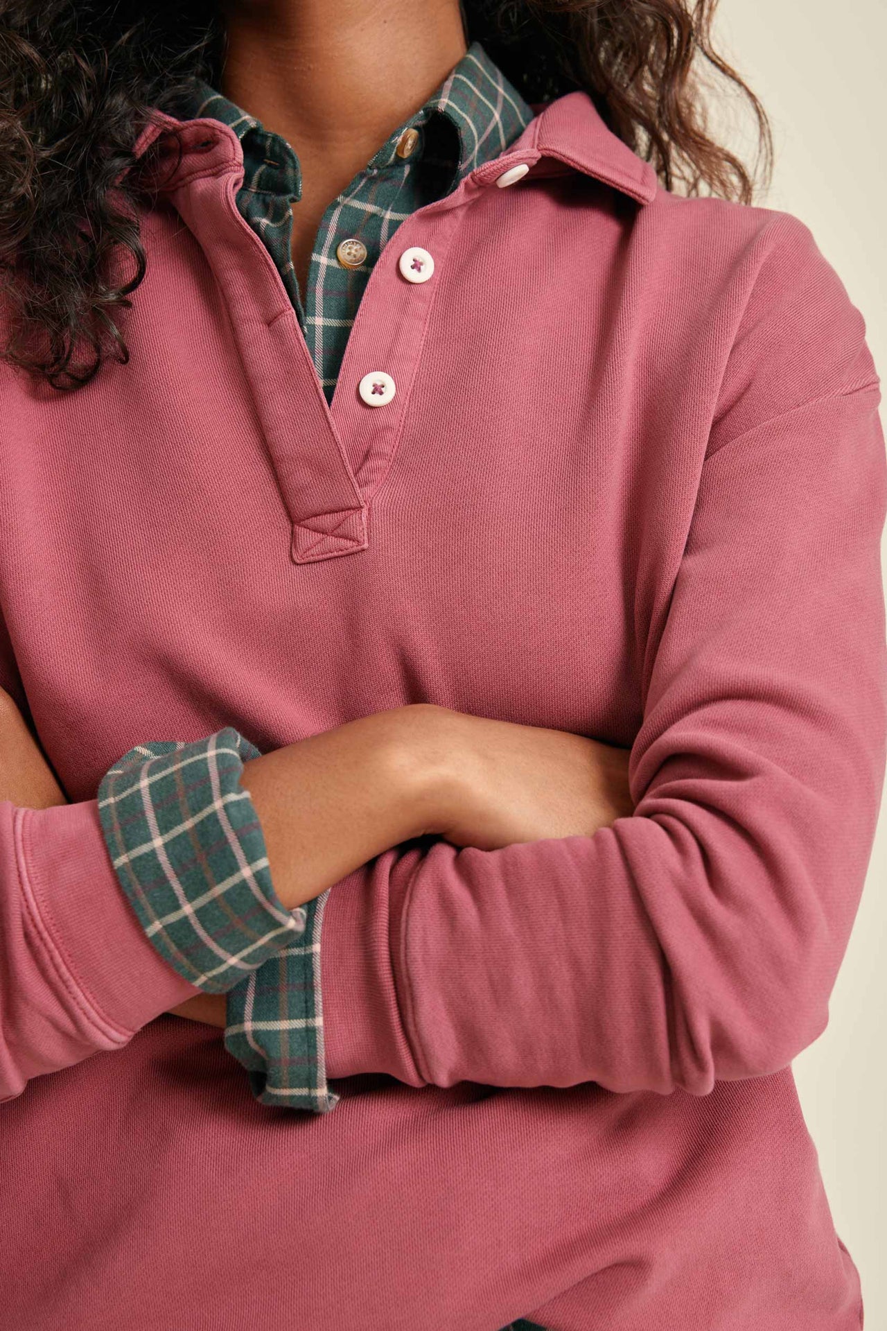 Person wearing a pink long-sleeve sweatshirt
