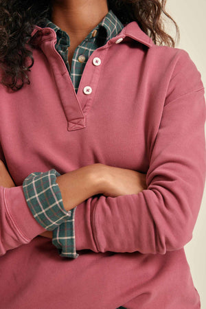 Person wearing a pink long-sleeve sweatshirt