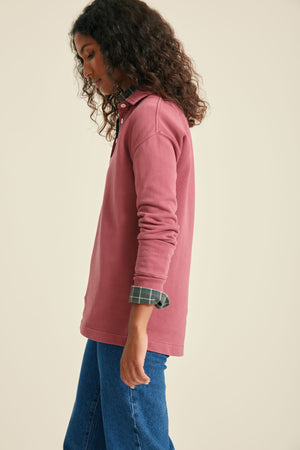 Person wearing a pink sweat with on a beige background