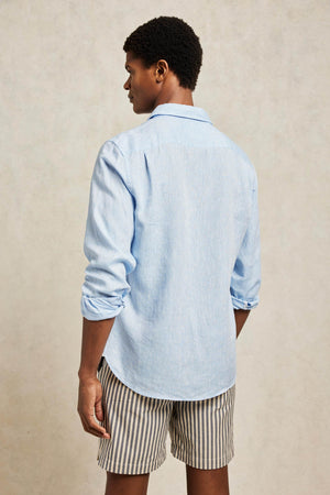 Soft pure linen shirt in sky blue Classic collar Contrast pink linen trim at back neck, sleeve placket and side gusset. Signature elephant embroidery and contrast colour button stitch at cuff Self-colour Beaufort embroidery on inside placket White branded buttons 100% linen Machine wash Model is 6’ 4", 40” chest, 32” w…