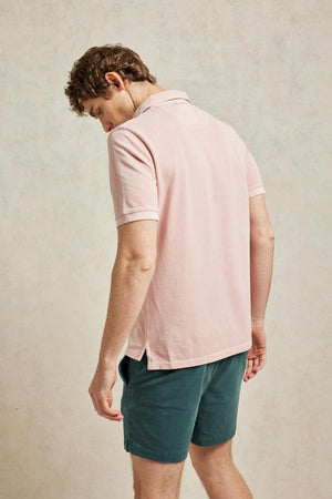 Classic cotton pique garment dyed men’s pink polo shirt washed for a soft touch. 100% cotton. With a subtle faded wash. Casual wear. Machine wash. Size S, M, L, XL, XXL.