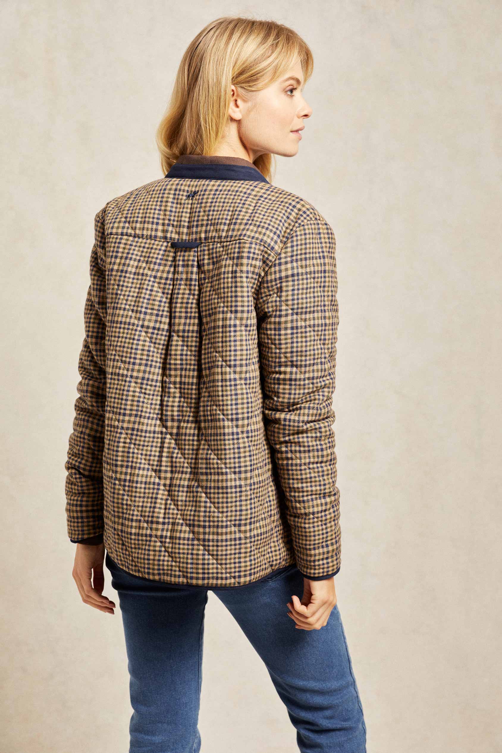 Diamond quilted women’s jacket with bespoke check design. An elevated take on a country classic, woven with a bespoke check and detailed with diamond quilting. Collarless design that's easy to layer and outlined with navy trims. Casual wear. Size XS, S, M, L, XL. Rubberised poppers to close.