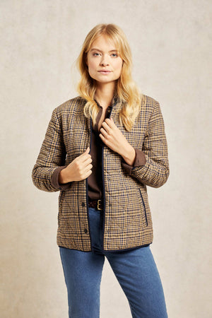 Diamond quilted women’s jacket with bespoke check design. An elevated take on a country classic, woven with a bespoke check and detailed with diamond quilting. Collarless design that's easy to layer and outlined with navy trims. Casual wear. Size XS, S, M, L, XL. Rubberised poppers to close. 