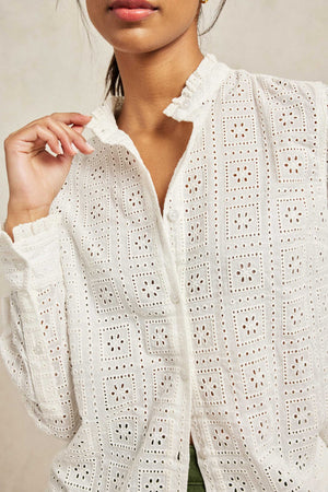 Willow Broderie shirt with ruffle detail at neck and cuffs. Cut from classic broderie anglaise to an elegant silhouette with darts at the bust. Ruffled trims and pearlised buttons. Casual wear. Size XS, S, M, L, XL. Machine wash.