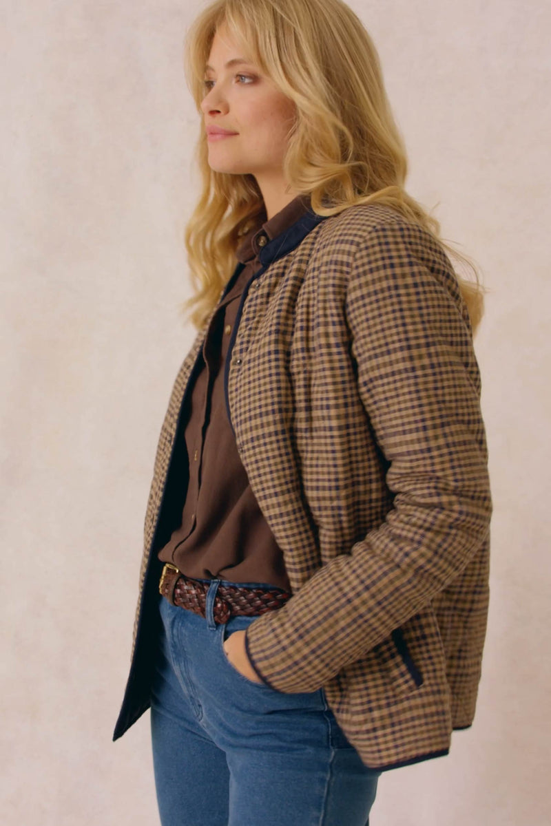 Diamond quilted women’s jacket with bespoke check design. An elevated take on a country classic, woven with a bespoke check and detailed with diamond quilting. Collarless design that's easy to layer and outlined with navy trims. Casual wear. Size XS, S, M, L, XL. Rubberised poppers to close.